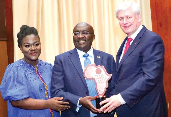 Vice-President Dr Mahamudu Bawumia (middle) receiving the award from Stephen Harper (right), a former Prime Minister of Canada, on behalf of President Akufo-Addo, at the Jubilee House. With them is Louisa Atta-Agyemang, the President of Young Democratic Union of Africa. Picture: SAMUEL TEI ADANO